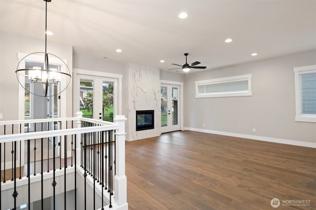 7585 S 130th Pl, Seattle, WA 98178 - unfurnished living room featuring french doors, recessed lighting, wood finished floors, ceiling fan, and a chandelier