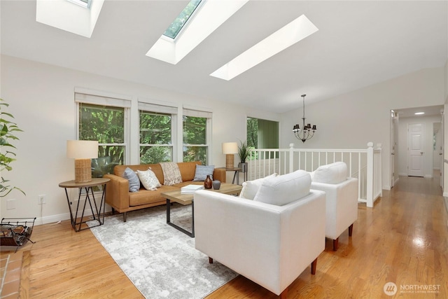 10435 NE 135th Pl, Kirkland, WA 98034 - living area with lofted ceiling, a skylight, a chandelier, and light wood finished floors