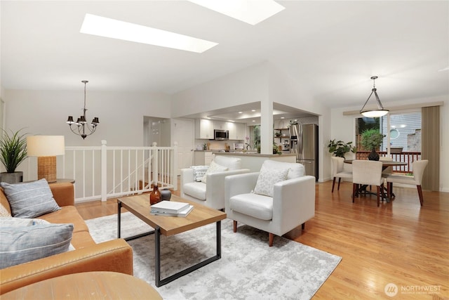10435 NE 135th Pl, Kirkland, WA 98034 - living room featuring light wood-type flooring, a skylight, a chandelier, and lofted ceiling