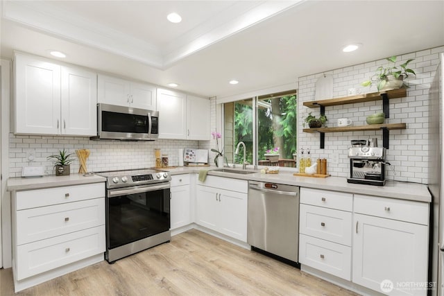 10435 NE 135th Pl, Kirkland, WA 98034 - kitchen with stainless steel appliances, backsplash, light countertops, recessed lighting, and ornamental molding