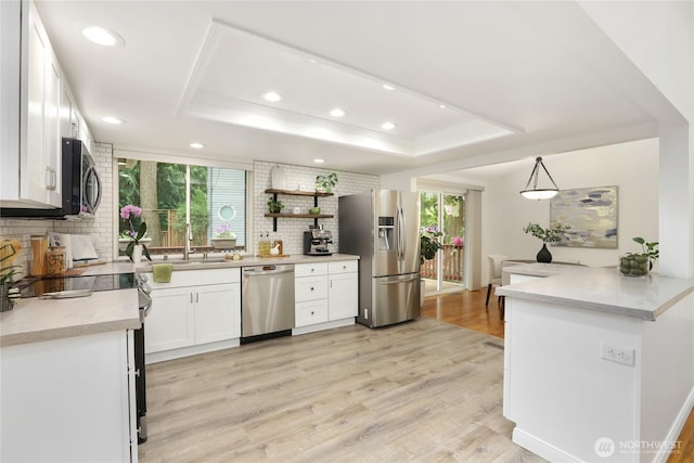 10435 NE 135th Pl, Kirkland, WA 98034 - kitchen featuring appliances with stainless steel finishes, a raised ceiling, backsplash, recessed lighting, and white cabinets