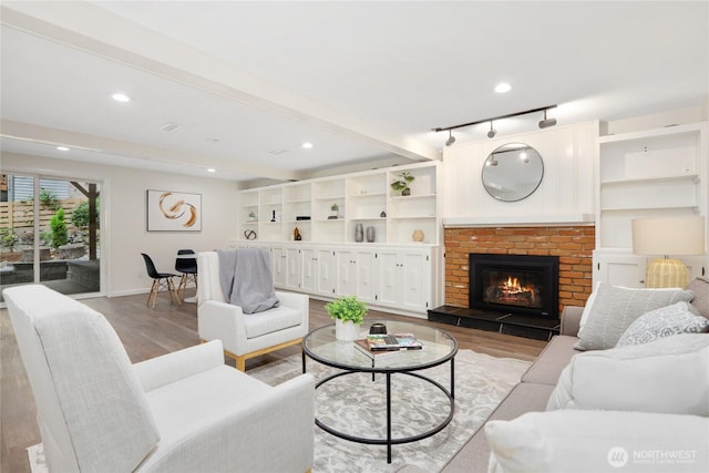 10435 NE 135th Pl, Kirkland, WA 98034 - living area with light wood-style flooring, a fireplace, track lighting, recessed lighting, and beam ceiling