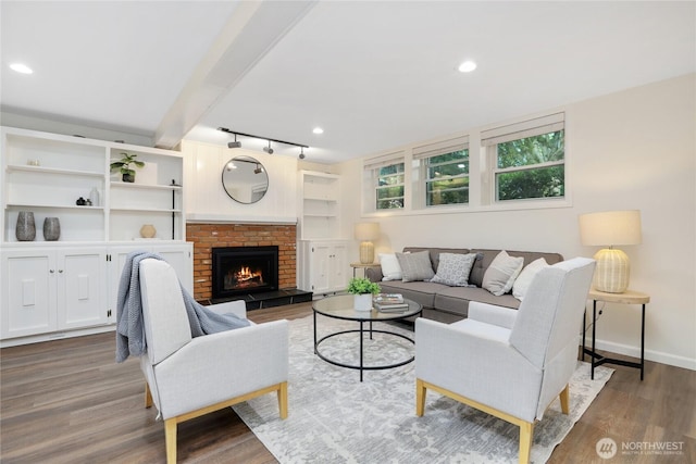 10435 NE 135th Pl, Kirkland, WA 98034 - living area with wood finished floors, rail lighting, a fireplace, and built in shelves