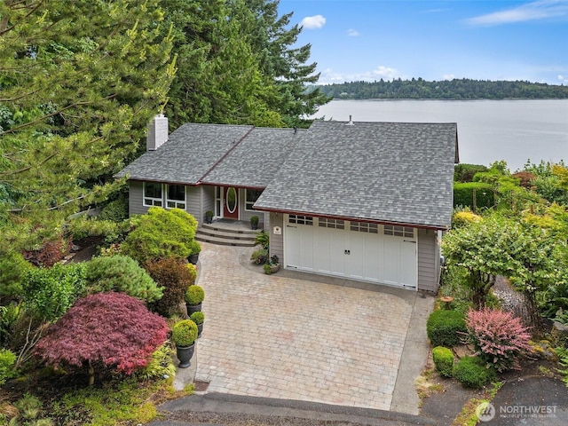 6600 Klein St NW, Olympia, WA 98502 - view of front of home with a shingled roof, a chimney, covered porch, a water view, and decorative driveway