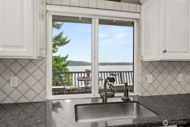 6600 Klein St NW, Olympia, WA 98502 - kitchen featuring backsplash, a water view, and white cabinetry