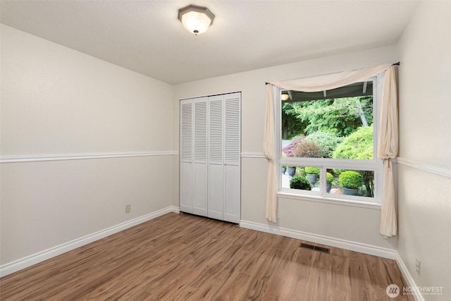 6600 Klein St NW, Olympia, WA 98502 - unfurnished bedroom featuring wood finished floors and a closet