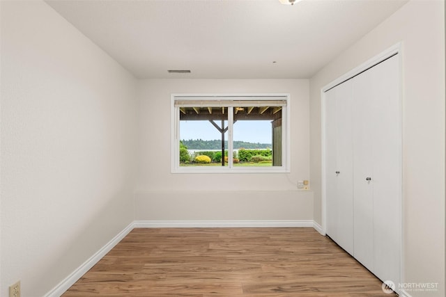 6600 Klein St NW, Olympia, WA 98502 - unfurnished bedroom with light wood-type flooring and a closet