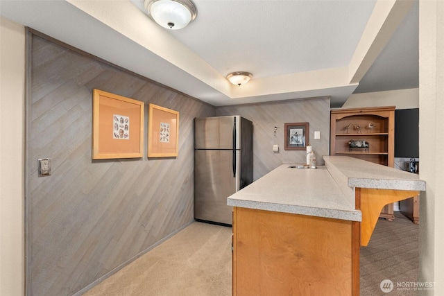 6600 Klein St NW, Olympia, WA 98502 - kitchen with freestanding refrigerator, light carpet, a peninsula, and light countertops