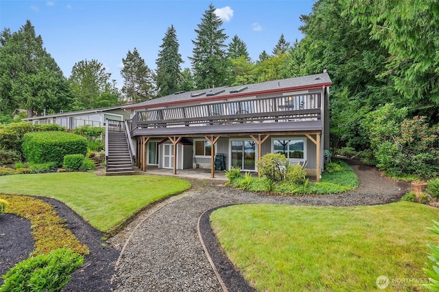 6600 Klein St NW, Olympia, WA 98502 - rear view of house featuring stairway, a deck, a lawn, and a patio area