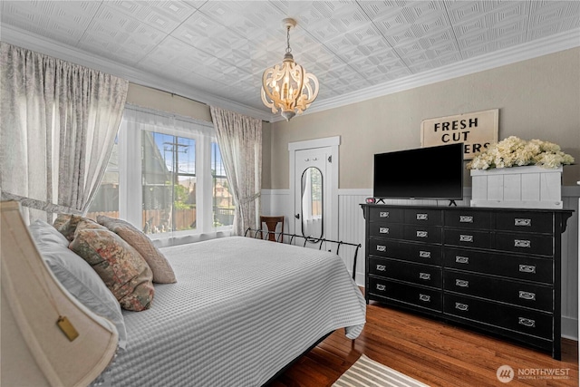 206 S Miller St, Wenatchee, WA 98801 - bedroom with a chandelier, an ornate ceiling, wood finished floors, a wainscoted wall, and ornamental molding