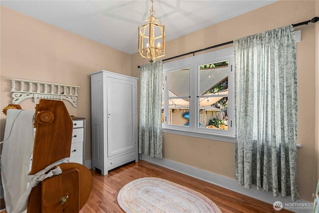 206 S Miller St, Wenatchee, WA 98801 - bedroom with wood finished floors, baseboards, and a chandelier