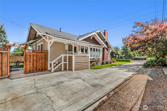 206 S Miller St, Wenatchee, WA 98801 - view of side of property with a shingled roof, concrete driveway, and a chimney