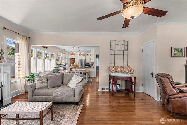 206 S Miller St, Wenatchee, WA 98801 - living area featuring wood finished floors, crown molding, ceiling fan, and baseboards