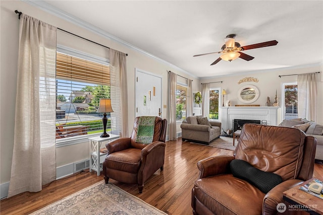 206 S Miller St, Wenatchee, WA 98801 - living area featuring wood finished floors, a ceiling fan, a fireplace, and crown molding