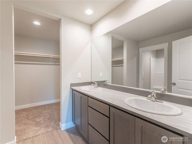 22 Salmon Dr, Wenatchee, WA 98801 - bathroom featuring double vanity, wood finished floors, a spacious closet, and recessed lighting