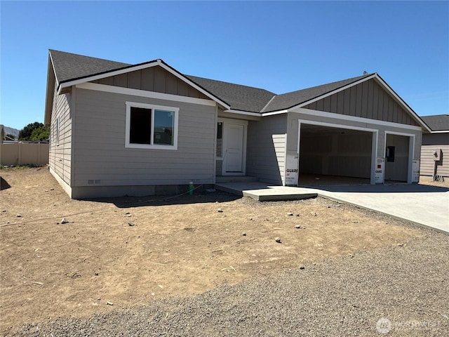 22 Salmon Dr, Wenatchee, WA 98801 - view of front facade featuring board and batten siding, a garage, concrete driveway, and a shingled roof