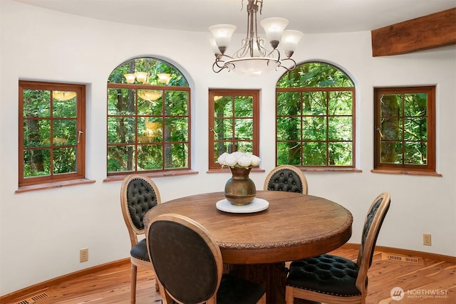 24917 Dockton Rd SW, Vashon, WA 98070 - dining area with a chandelier, wood finished floors, and plenty of natural light