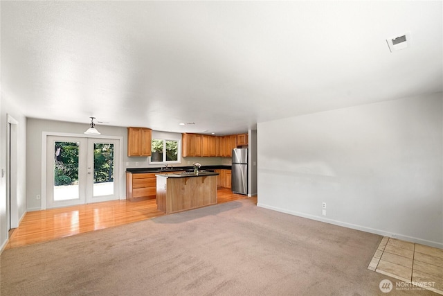 3003 193rd Pl SE, Bothell, WA 98012 - kitchen with freestanding refrigerator, dark countertops, open floor plan, light colored carpet, and a center island