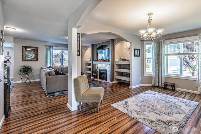 17716 25th Ave E, Tacoma, WA 98445 - living room featuring healthy amount of natural light, a chandelier, and dark wood-style flooring