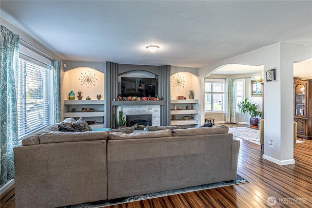 17716 25th Ave E, Tacoma, WA 98445 - living room with dark wood finished floors, healthy amount of natural light, a fireplace, and arched walkways