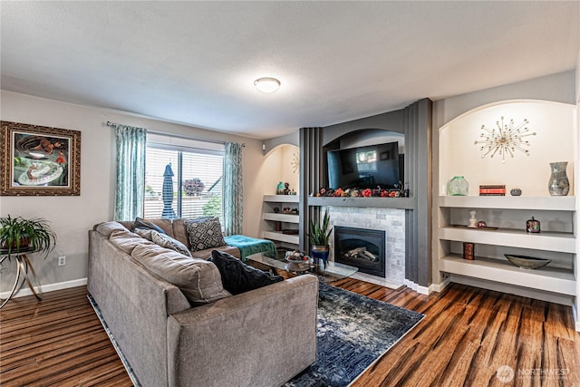 17716 25th Ave E, Tacoma, WA 98445 - living area with wood finished floors, a fireplace with flush hearth, built in features, and a textured ceiling