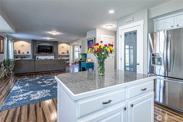 17716 25th Ave E, Tacoma, WA 98445 - kitchen featuring stainless steel refrigerator with ice dispenser, arched walkways, white cabinetry, dark wood finished floors, and recessed lighting