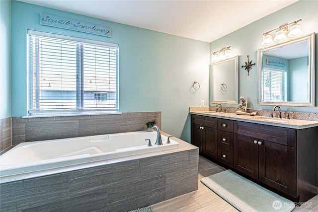 17716 25th Ave E, Tacoma, WA 98445 - full bathroom with plenty of natural light, double vanity, a garden tub, and wood finished floors