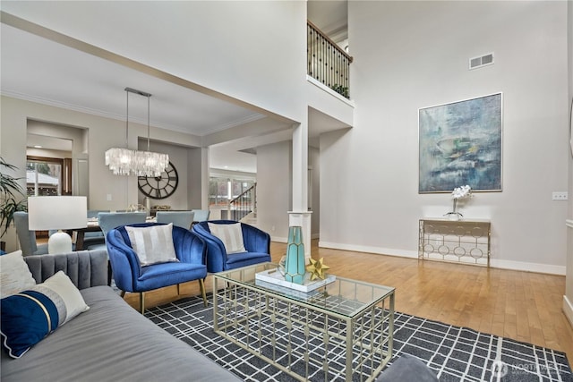 13020 112th Ave NE, Kirkland, WA 98034 - living room featuring wood finished floors, a chandelier, and ornamental molding