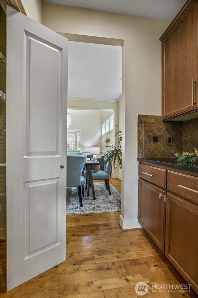 13020 112th Ave NE, Kirkland, WA 98034 - kitchen with light wood finished floors, dark countertops, and backsplash