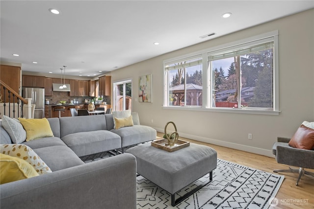 13020 112th Ave NE, Kirkland, WA 98034 - living room featuring plenty of natural light, recessed lighting, light wood-style flooring, and stairs