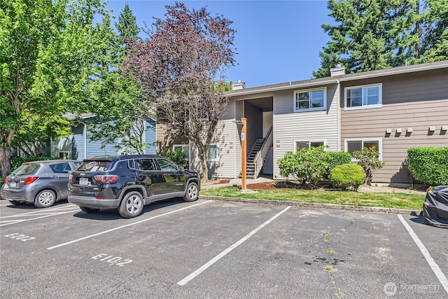 921 130th St SW Unit E102, Everett, WA 98204 - view of building exterior featuring uncovered parking and stairway