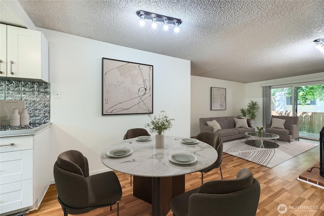 921 130th St SW Unit E102, Everett, WA 98204 - dining area with a textured ceiling and light wood-style floors