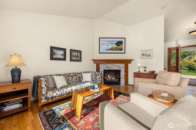 115 Quarry Rd, Port Ludlow, WA 98365 - living room with lofted ceiling, wood finished floors, and a tiled fireplace