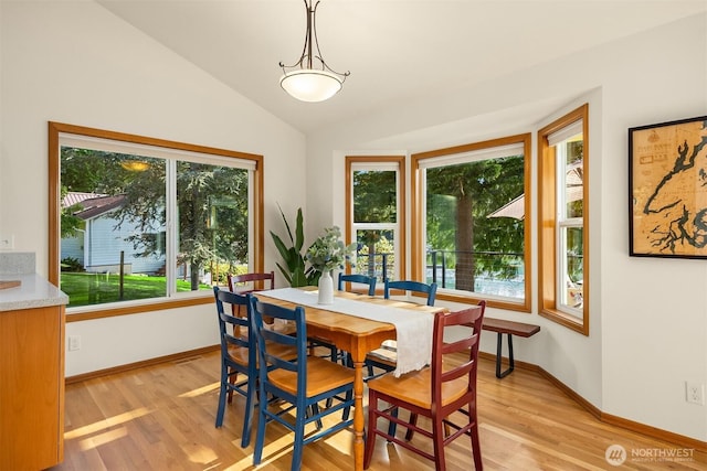 115 Quarry Rd, Port Ludlow, WA 98365 - dining room featuring light wood-style flooring and vaulted ceiling