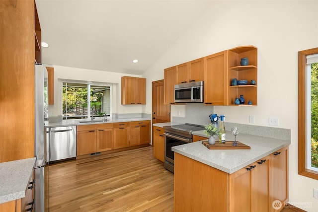115 Quarry Rd, Port Ludlow, WA 98365 - kitchen with appliances with stainless steel finishes, light wood-style floors, open shelves, healthy amount of natural light, and lofted ceiling