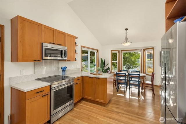 115 Quarry Rd, Port Ludlow, WA 98365 - kitchen with appliances with stainless steel finishes, a peninsula, light countertops, open shelves, and light wood-style flooring