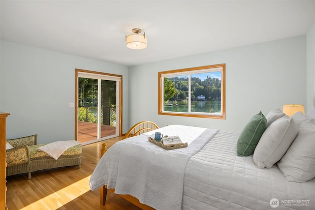 115 Quarry Rd, Port Ludlow, WA 98365 - bedroom with access to outside, multiple windows, and wood finished floors