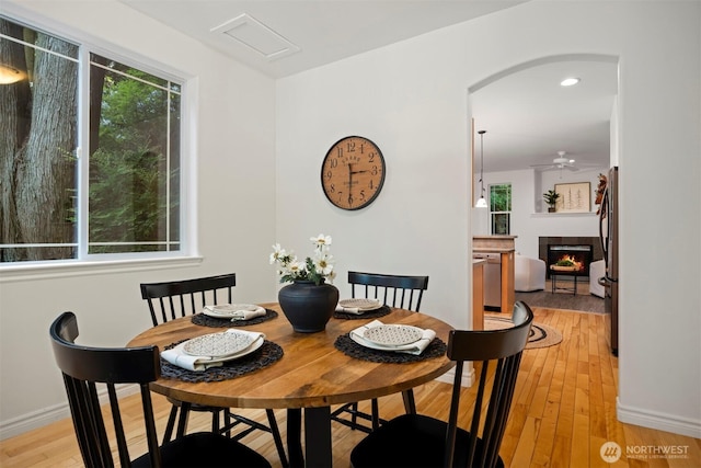 3 Spring Rd, Bellingham, WA 98229 - dining space with plenty of natural light, a fireplace, light wood-style flooring, arched walkways, and recessed lighting