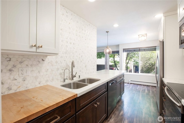 525 Lebo Blvd Unit G3, Bremerton, WA 98310 - kitchen featuring a baseboard radiator, dark wood-type flooring, white cabinets, backsplash, and appliances with stainless steel finishes