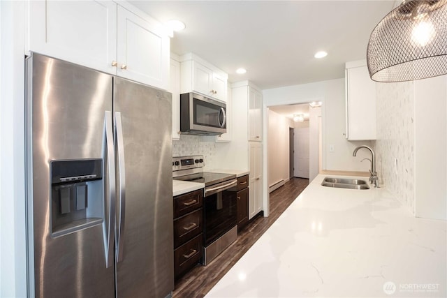 525 Lebo Blvd Unit G3, Bremerton, WA 98310 - kitchen with stainless steel appliances, white cabinetry, dark wood-style flooring, decorative backsplash, and baseboard heating