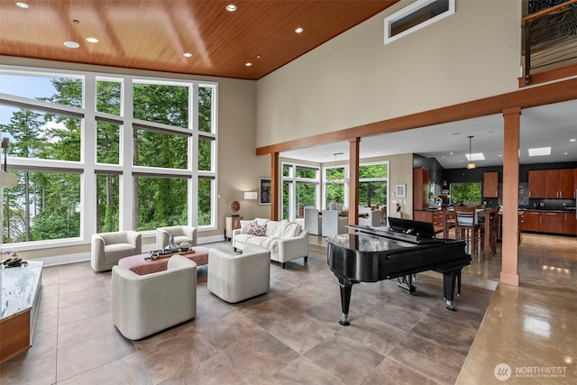 182 Island Blvd, Fox Island, WA 98333 - living area with wooden ceiling, a towering ceiling, plenty of natural light, recessed lighting, and decorative columns