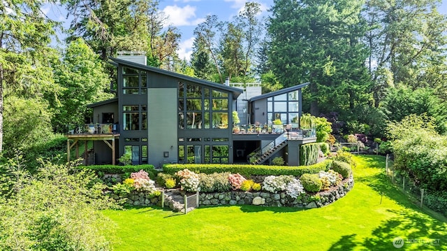 182 Island Blvd, Fox Island, WA 98333 - back of property featuring stairs, a sunroom, a wooden deck, and a yard