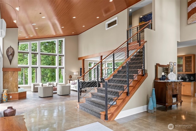 182 Island Blvd, Fox Island, WA 98333 - stairway featuring a high ceiling, concrete floors, recessed lighting, and wooden ceiling