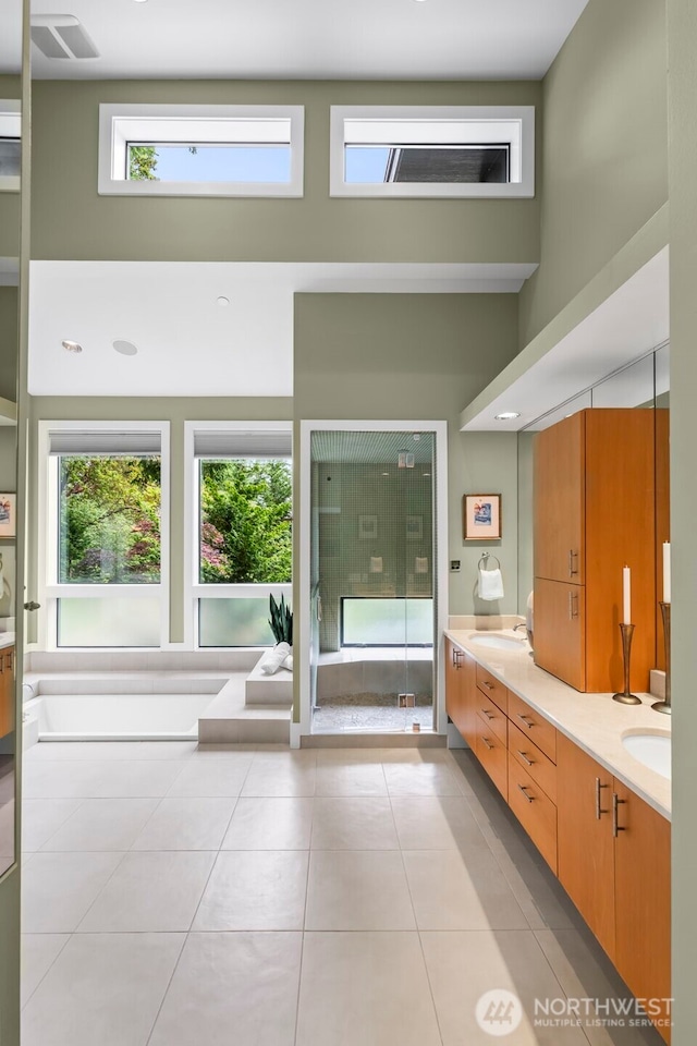 182 Island Blvd, Fox Island, WA 98333 - bathroom featuring double vanity, tile patterned flooring, and a shower stall