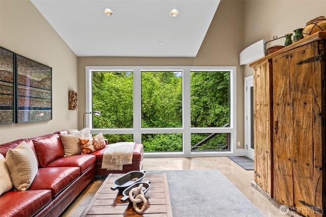 182 Island Blvd, Fox Island, WA 98333 - living room featuring a wall unit AC, vaulted ceiling, and recessed lighting
