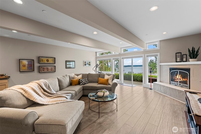 182 Island Blvd, Fox Island, WA 98333 - living area featuring wood finished floors, beamed ceiling, a fireplace, recessed lighting, and a water view