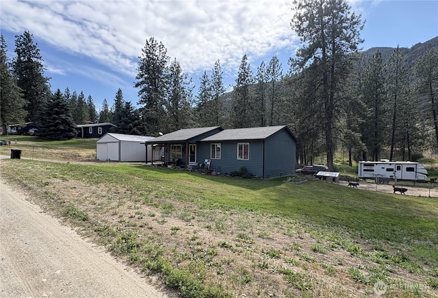47 Pinecrest Rd, Tonasket, WA 98855 - view of front facade featuring a front yard, a shed, and a wooded view