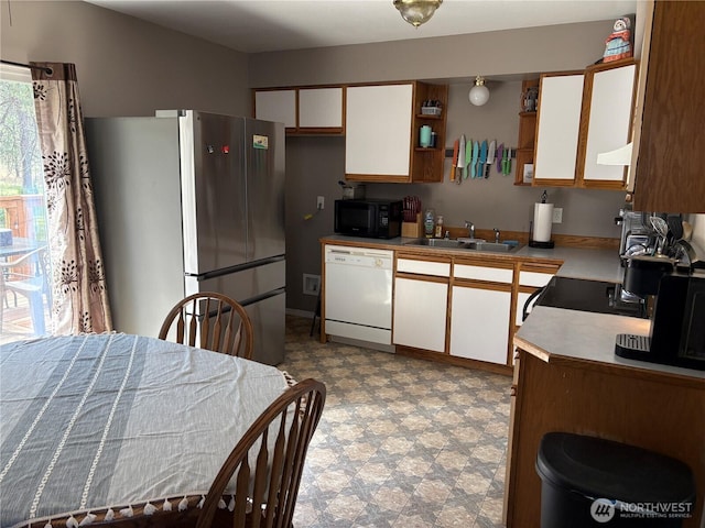 47 Pinecrest Rd, Tonasket, WA 98855 - kitchen featuring white dishwasher, freestanding refrigerator, black microwave, white cabinets, and tile patterned floors