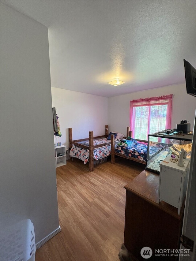 47 Pinecrest Rd, Tonasket, WA 98855 - bedroom with light wood finished floors and a textured ceiling