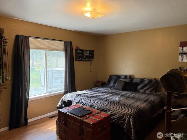 47 Pinecrest Rd, Tonasket, WA 98855 - bedroom with multiple windows and light wood-type flooring